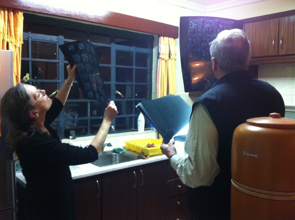 Leland and wife Susan reading Riley's MRI. Leland had moments before returned from a four day visit to Australia lecturing on pediatric neurosurgery.
