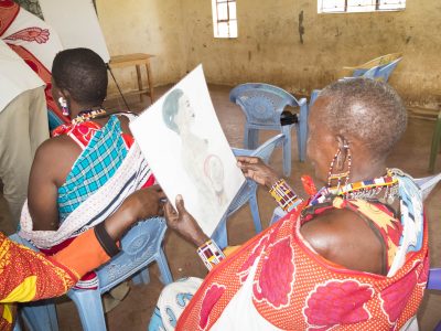 Training Maasai Community Health Volunteers with simple diagrams and tools.